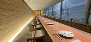 a long dining room with a long table and chairs at 住 京都小川生薬 VILLA Jyu KyotoOgawaSyouyaku VILLA in Kyoto +171 photos