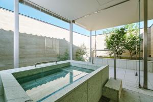 a swimming pool in a house with a large window at 住 京都小川生薬 VILLA Jyu KyotoOgawaSyouyaku VILLA in Kyoto