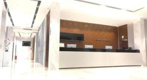a lobby with a reception desk in a building at City Comfort Inn Shenzhen Shiyan Science and Technology Park in Xin'an