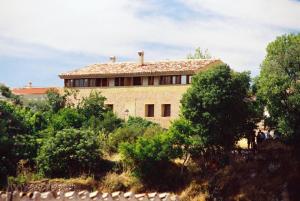 a house on top of a hill with trees at Casas Rurales El Parador in Letur