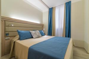 Postel nebo postele na pokoji v ubytování L'Ambasciata Hotel de Charme