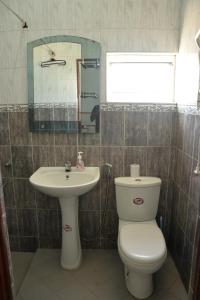 a bathroom with a toilet and a sink at Happy Tuna Beach Apartment in Hikkaduwa +94 photos