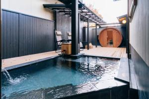 a pool of water in front of a building at Tawarayama Onsen Ryokan Minawa in Minami Aso