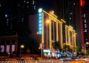 a building with a sign on it at night at City Comfort Inn Kunming Xinluojiu Bay Guangju Road in Kunming