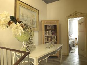 a room with a table with a vase of flowers on it at Antica Loggetta in Ravenna