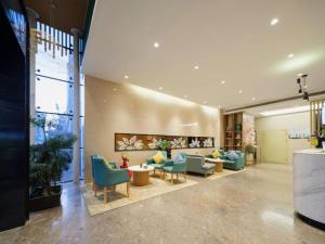a lobby with couches and chairs in a building at GreenTree Inn Luoyang Railway Station Wangfujing Wangcheng Park in Luoyang