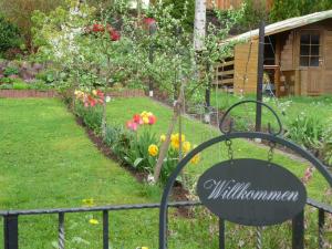 a garden with a gate with a bunch of flowers at Ferienwohnung Bruni in Birresborn