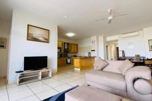 a living room with a couch and a tv at Colonial Sands 8 sleeper with Jacuzzi in Margate
