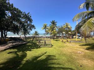 a park with a playground with palm trees and the beach at Jubiabá - 1110 A - Net 200 MB in Ilhéus