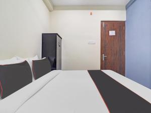 Ένα ή περισσότερα κρεβάτια σε δωμάτιο στο Hotel O SQUARE UNIQUE SUITES