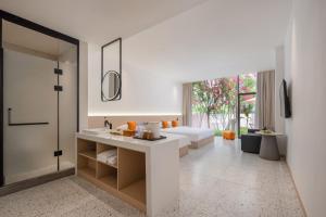 a bathroom with a bed and a sink in a room at Yangshuo Yundu Panoramic Luxury Hotel in Xingping +42 photos