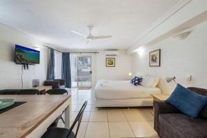 a living room with a bed and a couch at Shoreline Apartments - Unit 4a in Bargara