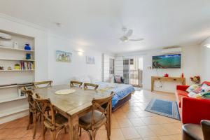 a living room with a table and a bed at Shoreline Apartments - Unit 9a in Bargara