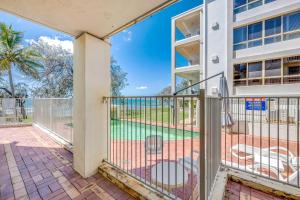a balcony with a view of a pool at Shoreline Apartments - Unit 9a in Bargara