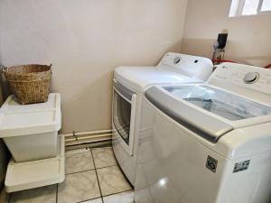 a laundry room with a washing machine and a basket at Harmony House Homestay in Sedona