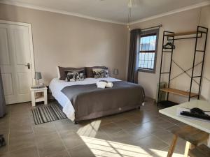 a bedroom with a large bed in a room at Alcyone in Gqeberha