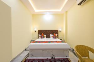 a bedroom with a large bed in a room at FabHotel Rubicon in Faridabad