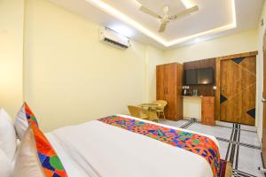 a hotel room with a bed and a kitchen at FabHotel Rubicon in Faridabad
