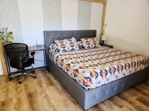 a bedroom with a bed and a desk and a chair at Harmony House Homestay in Sedona