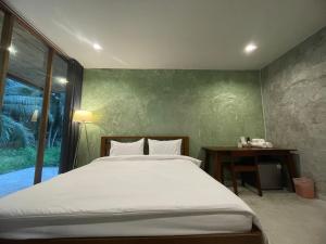 Кровать или кровати в номере COCO Home 2 โคโค่โฮม เฟส 2