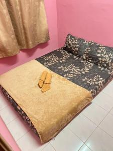 Ένα ή περισσότερα κρεβάτια σε δωμάτιο στο Amani guesthouse