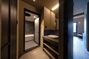 a bathroom with a sink and a tub at 中尾甚六Hotel in Karatsu +52 photos