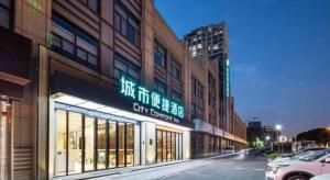 a building with a sign on the side of a street at City Comfort Inn Suzhou Wujiang Development Zone Yundong in Suzhou