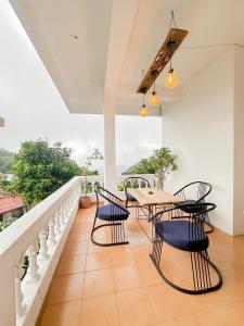 a dining room with a table and chairs on a balcony at Cloud Nest Hanthana in Kandy