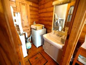 a bathroom with a sink and a toilet and a mirror at Niseko Izumikyo in Kutchan +89 photos
