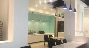 a kitchen with a table and chairs in a room at Jinjiang Inn Jiaxing South Lake in Jiaxing