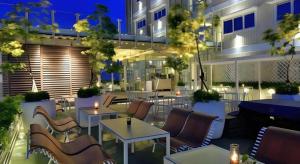 a restaurant with tables and chairs in front of a building at Gajahmada Avara Boutique Hotel in Siantan