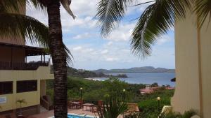 a view of the ocean from a hotel balcony at Sunset Heights 402 in Playa Flamingo