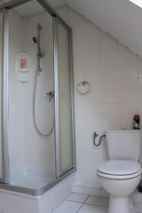 ein Badezimmer mit Dusche und Toilette in der Unterkunft GLÜCKSHAUS Ferienwohnung in Cuxhaven + 11 Fotos
