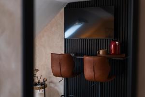 a room with two chairs and a mirror at Lovely 2 Rooms Next to Sint-Niklaas Very Central in Ghent