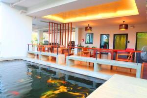 a swimming pool with a koi in a house at The Pride in Sathani Wat Suwan