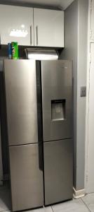 a stainless steel refrigerator in a kitchen at Diamondfield trading guesthouse in Kimberley