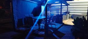 a table and chairs on a patio at night at Diamondfield trading guesthouse in Kimberley