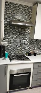 a kitchen with a stove top oven in a kitchen at Diamondfield trading guesthouse in Kimberley +4 photos