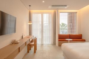 콘스트호텔 في Hyŏpchae-ri: غرفة فندق بها سرير وأريكة