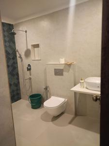 a bathroom with a shower and a toilet and a sink at REWOGA Gaia Resort - Luxury Rooms with Open-Air Shower in Arambol