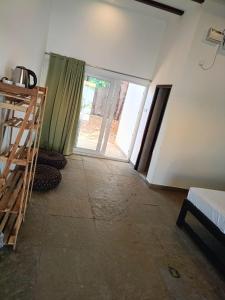 an empty room with a door to a bedroom at REWOGA Gaia Resort - Luxury Rooms with Open-Air Shower in Arambol