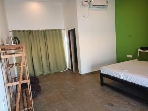 a room with a bed and a ladder next to a bedroom at REWOGA Gaia Resort - Luxury Rooms with Open-Air Shower in Arambol +12 photos