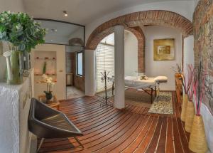 a living room with a wooden floor and a bedroom at Alqueria de Carrion Hotel Boutique in Atlixco +30 photos