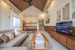 a living room with a couch and a tv at Diamond Hill Villa in Labuan Bajo