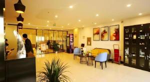 a lobby of a store with a man standing in it at Jinjiang Inn JiNan Daminghu New Scenic Area Lishan Road in Jinan