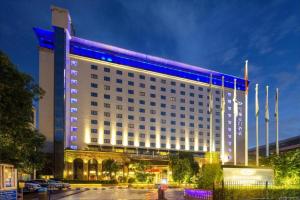 a large building with blue lights on it at Xian Grand Noble Hotel in Xi'an