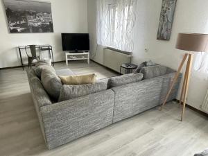 a living room with a couch and a flat screen tv at Schicke Ferienwohnung Philippsburg in Philippsburg