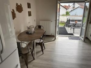 a table and chairs in a room with a balcony at Schicke Ferienwohnung Philippsburg in Philippsburg