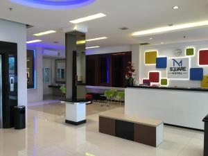 a lobby with a waiting area in a building at MSquare Palembang in Palembang