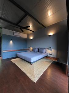 a bedroom with a large bed with a rug at Elevate Ella Resort & Spa in Ella +21 photos